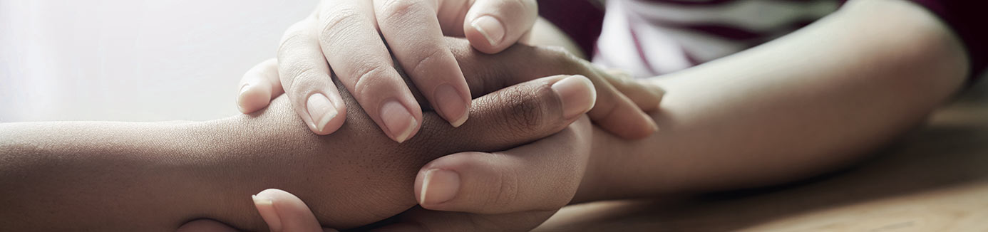 behavioral health specialist holding patient's hands