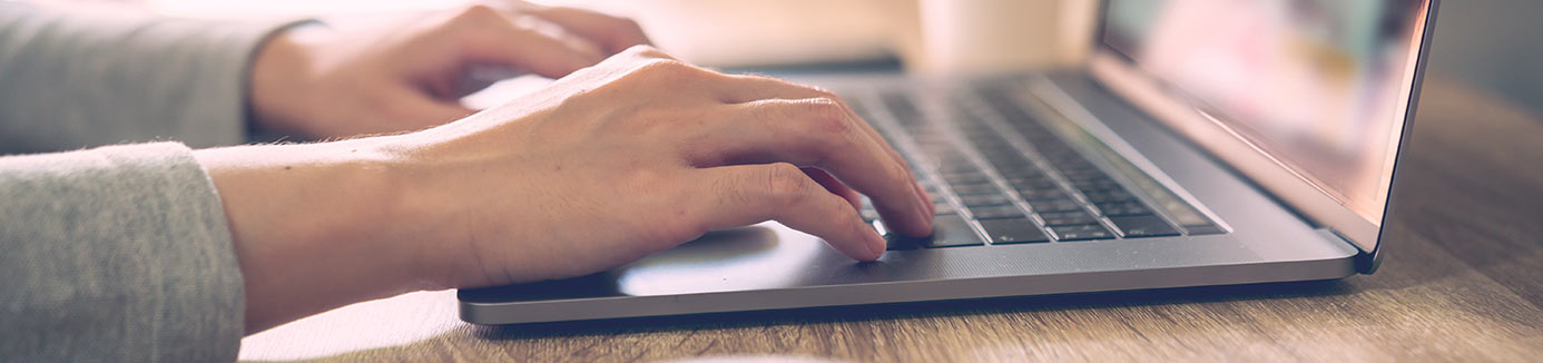 woman typing on her laptop