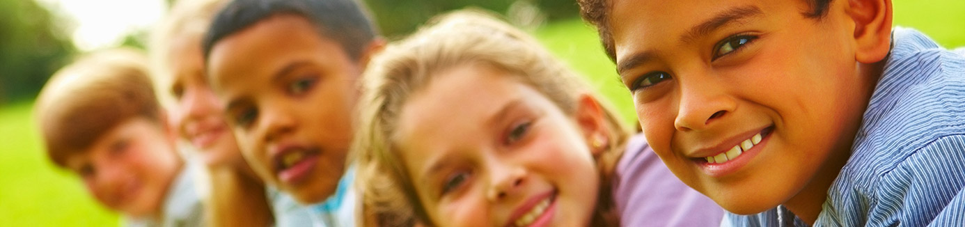 children lying on the grass