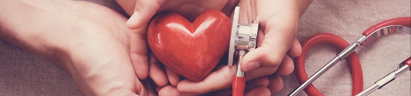 hands holding a heart and stethoscope