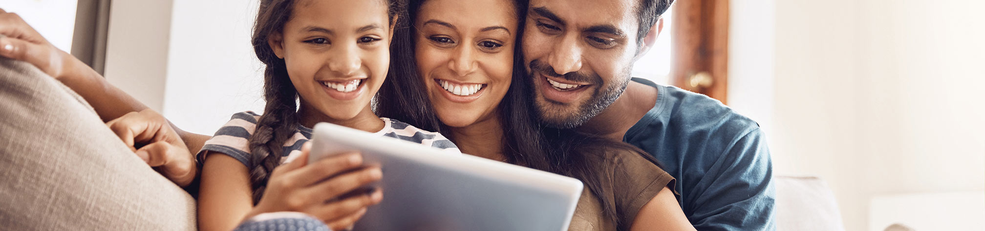 family looking at an ipad together