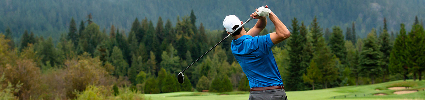 Man playing golf, mid-swing