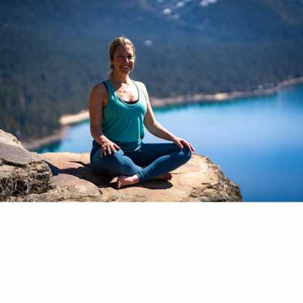 Rachel Durben on rock in front of lake