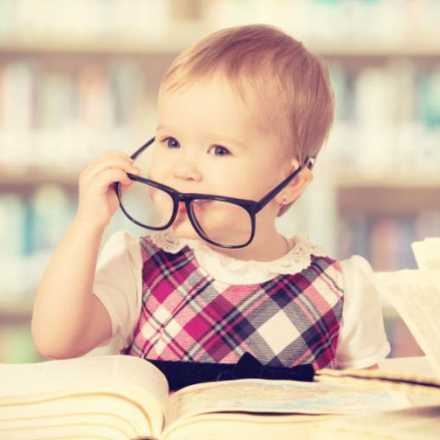 Baby wearing glasses at library