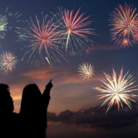 Dad holding child watching fireworks