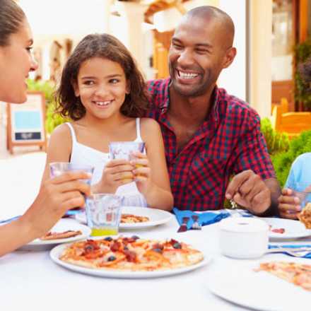 Family laughing and enjoying a meal