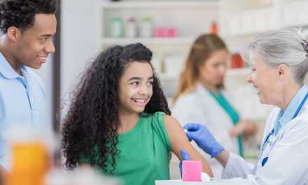 Young girl getting vaccine at pharmacy