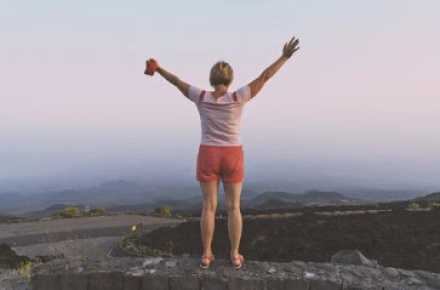 woman holding arms up wide