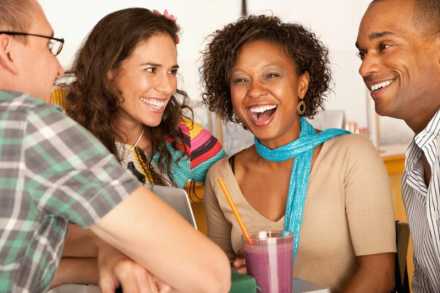 Two women and two men laughing together