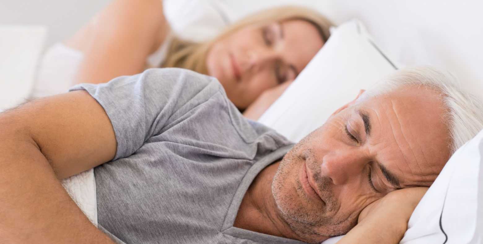 Couple sleeping on bed