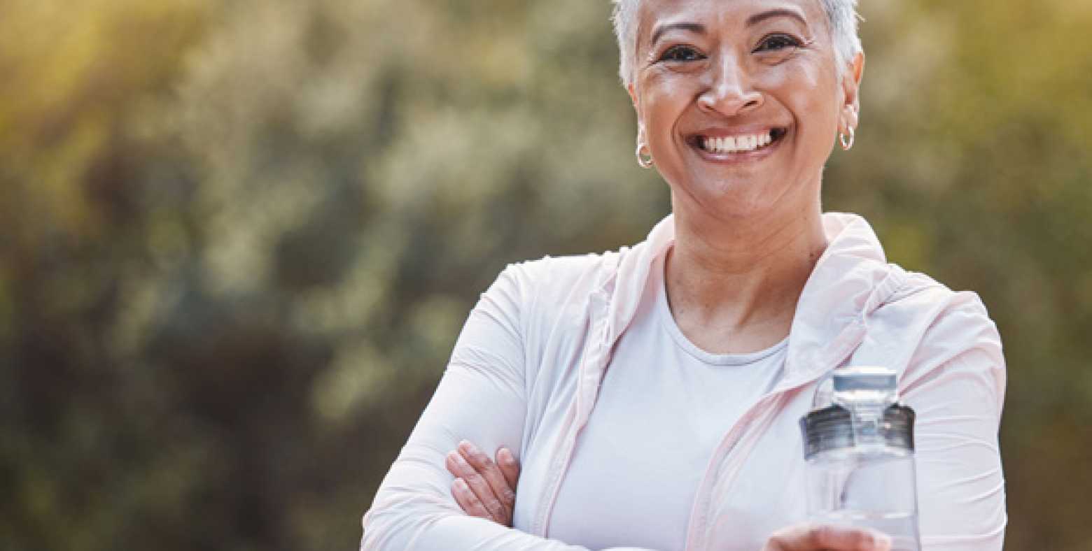 fit senior woman holding water bottle