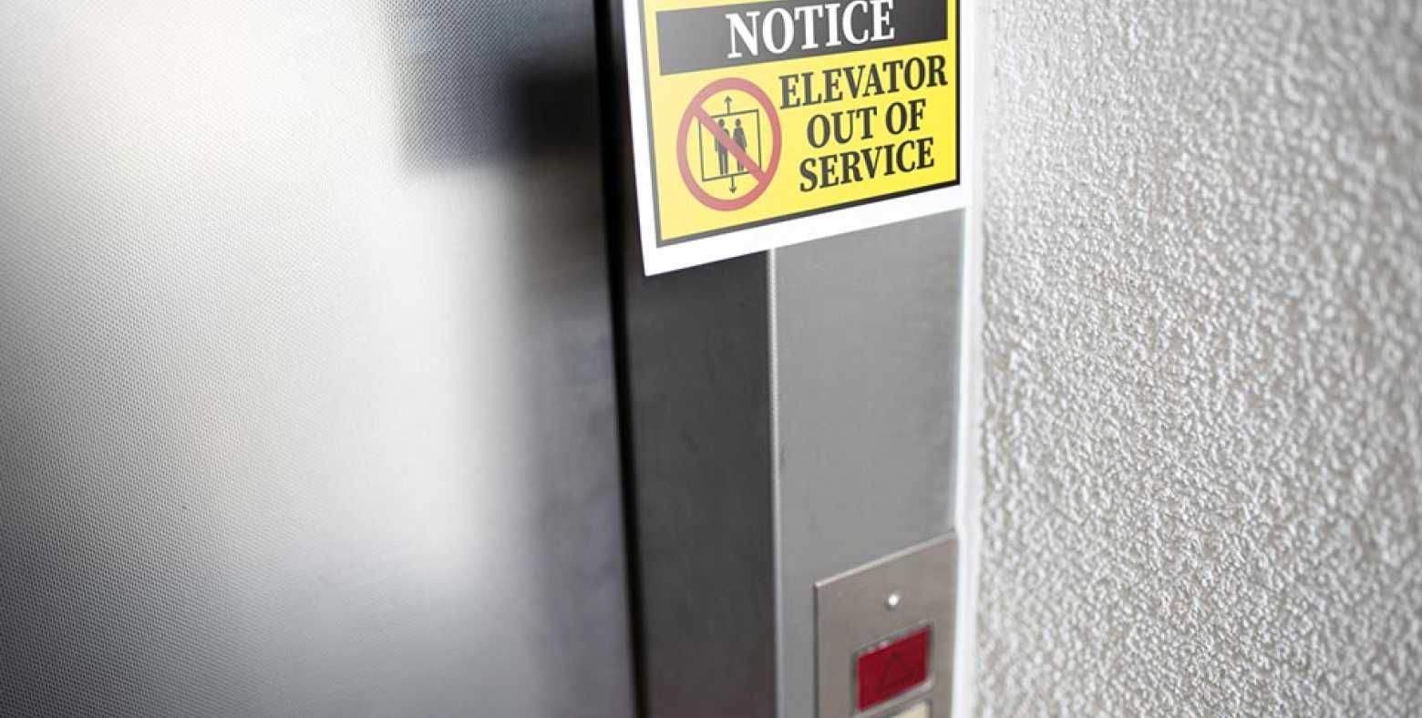 Exterior of an elevator with "Elevator out of service" sign