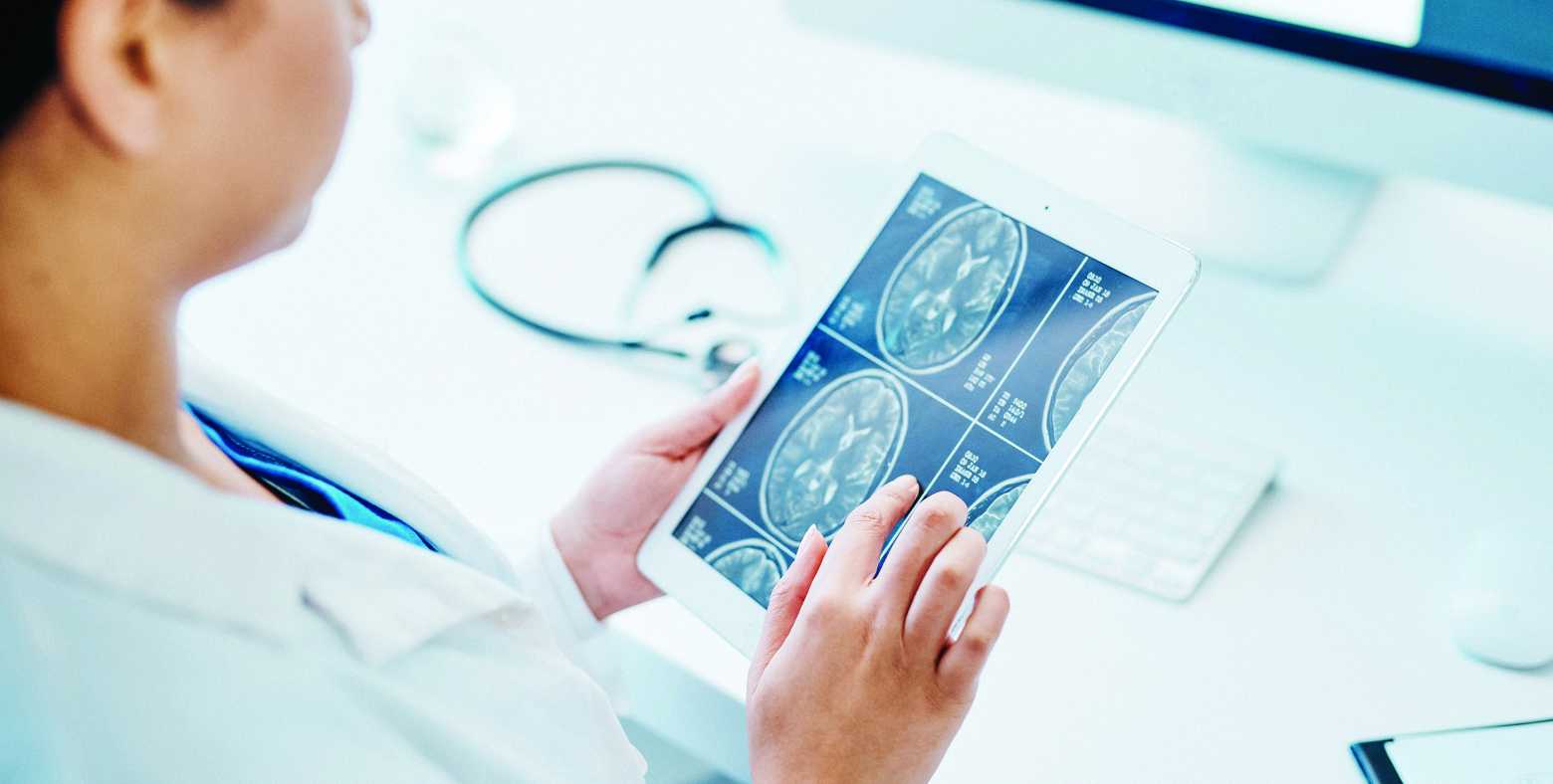 Doctor reviewing an MRI on an ipad