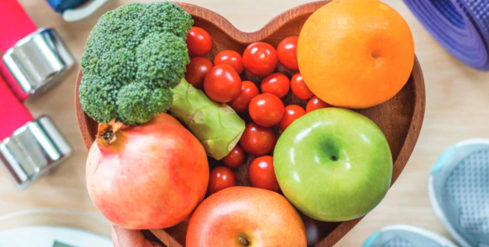 Heart shaped bowl of fruits and vegetables