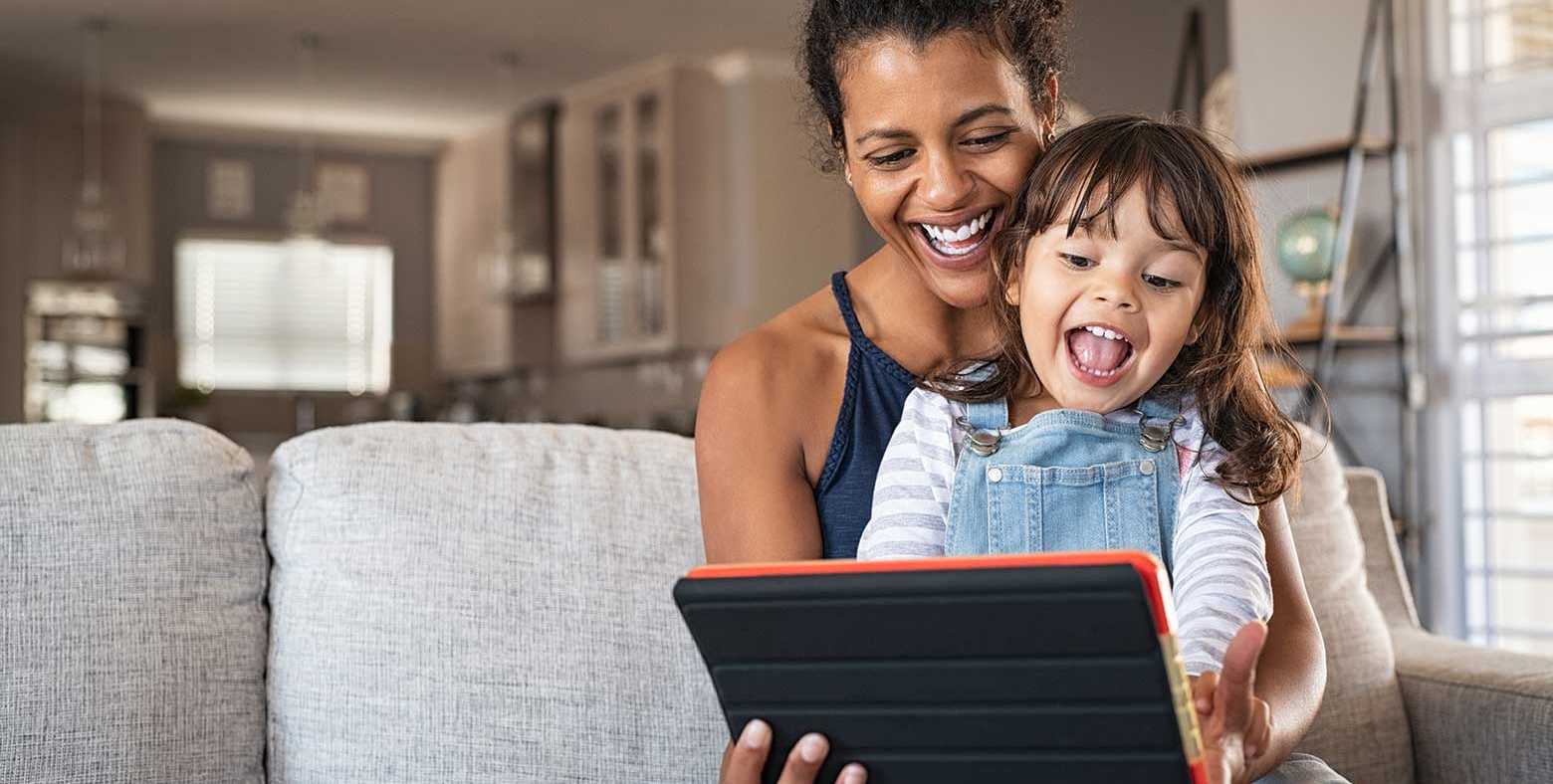 Mom and daughter reading on tablet