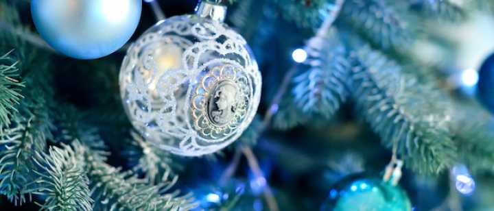 close up of hues of blue holiday ornaments on christmas tree