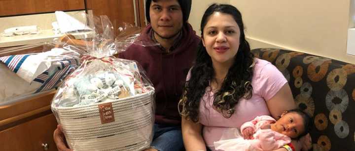 Father, Christian Meraz, Mother, Mayra Silva, and first baby of the new year, Leah Alessandra Meraz, with a gift basket donated by Tahoe Forest Health System Foundation’s gift shop, The Gift Tree 