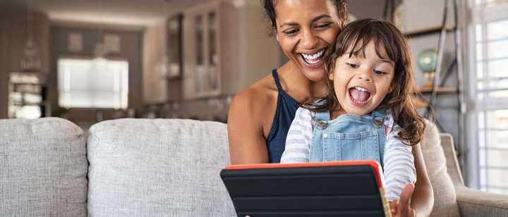 Mom and daughter reading on tablet