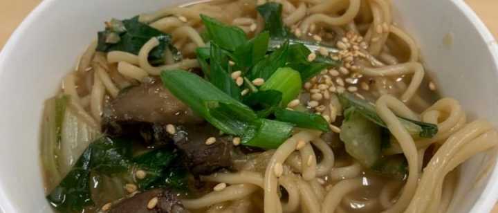 Bowl of ginger garlic noodle soup with bok choy